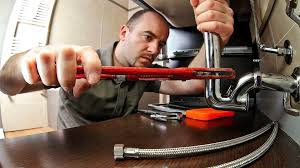Plumber clearing a drain line in El Paso